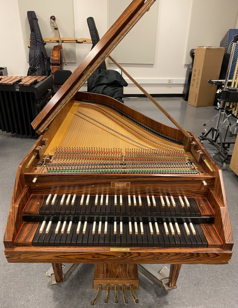 A fine Neupert harpsichord made in Germany with two keyboard manuals and four string registers.